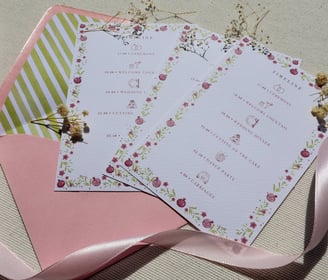 weekend details card with flowers and pink ribbon