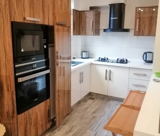 swiss cottages kitchen with a wooden floor and a table with a wooden table and chairs