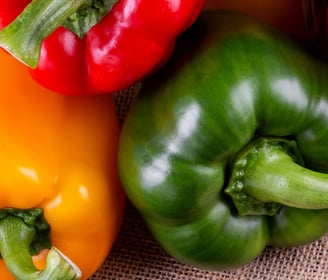 a basket of peppers and peppers on a table