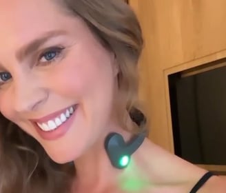 a woman with a green light up in the dark