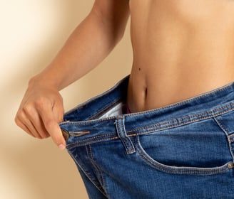 a woman in a blue top and jeans jeans