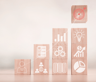 a wooden block with a building made of wood blocks showing continuous business improvements
