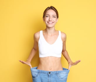 a woman in a white bra top and jeans jeans