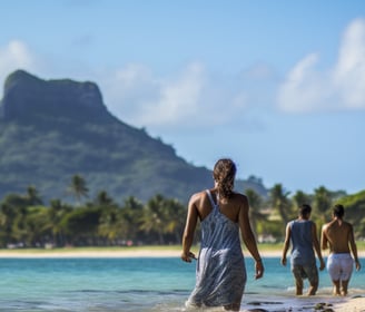 a group of travelers walking on the beach of Mauritius