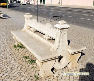 An old bench on old cobblestones on front of the Belem Palace & a shadow of Alonga Travel the author