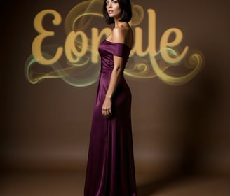 Vivienne Vale in a plum gown stands poised before golden script on a warm-toned backdrop.
