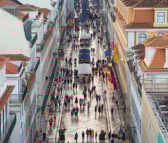 a city street scene with people walking down a street