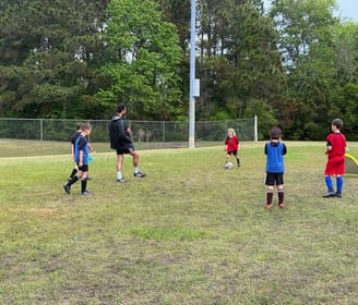 <img src="your-image-path.jpg" alt="Crestline FC coach leading a small-group soccer session with you