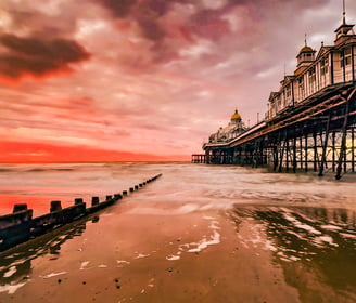 Eastbourne Pier, the sea and a groin at sunrise