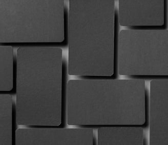 a black and white photo of a wall of squares of black squares