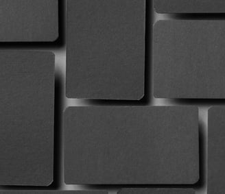 a black and white photo of a wall of squares of black squares