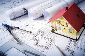 a house model of a house on top of a blueprint