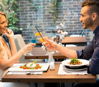 a man and woman are having a drink together