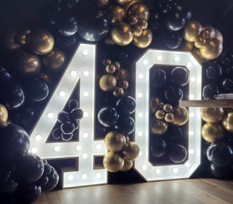 40th marquee and gold and black balloon garland