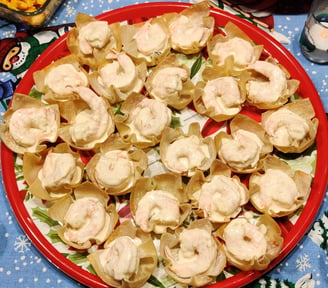 A top down view of Christmas platter full of Mango-Curry Shrimp Salad in Wonton Cups