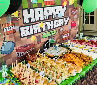 a table with a bunch of food and balloons
