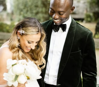 Groom walking around bride to admire her wedding dress during their first look