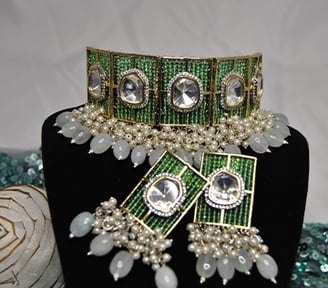 a bridal look necklace with a green beads and pearls