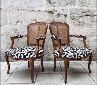 two chairs with a black and white patterned seat