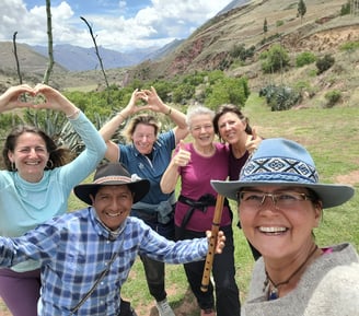a group of people standing infront of the south gate of Cusco Valley