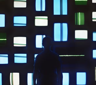a man standing in front of a wall with multiple colored squares