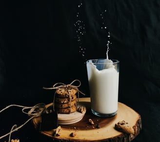 a glass of milk with cookies