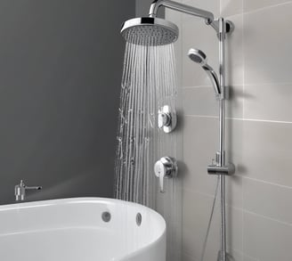 A blue satellite dish with the DSTV logo mounted on a pole. The dish is facing upwards against a clear blue sky, with a cable attached to the arm supporting the dish.