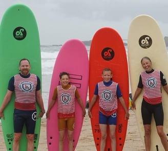 a group of people standing on a beach