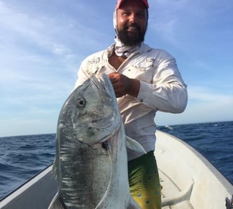 Latham Island Fishing Charters Zanzibar - Angler proudly holding a Giant Trevally