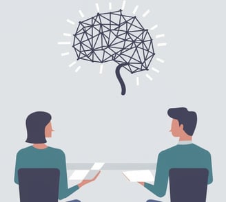 a man and woman sitting at a table with a brain map of a brain