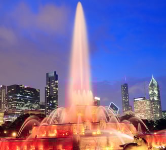 a fountain fountain with a city skyline in the background