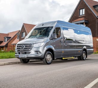 Silver Mini Bus parked on the side of a road