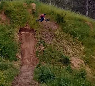 Rider turning mid-air on a hip jump, angling sideways