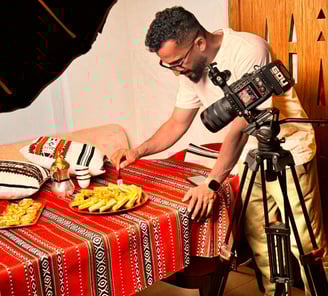 a man is taking a picture of a plate of food