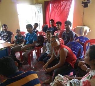 a group of people sitting around a table