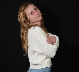 a woman in jeans and a white sweater