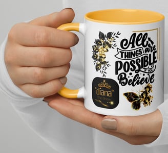 Female holding a white coffee/tea cup that is colored yellow inside