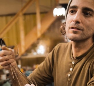 Izzy Lugo restringing a vintage Gibson guitar