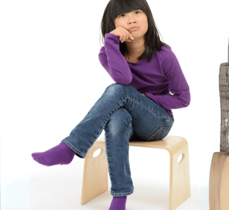 Girl wearing jeans and purple long sleeve t-shirt