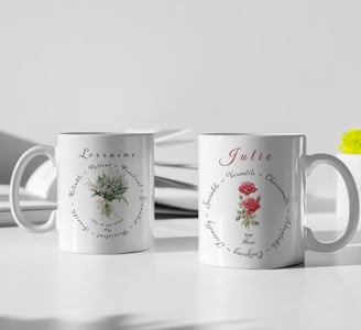 Two personalised white ceramic mugs featuring May and June birth flowers – a rose and a lily of th