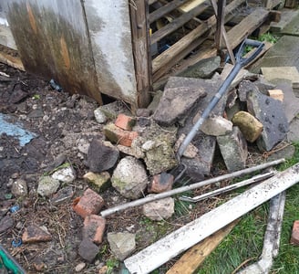 a pile of rubble and rubble in a yard