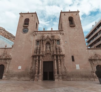 a large church with a clock - Basilica of St Mary of Alicante