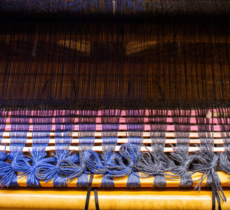 The start of a weaving project tied up on a loom.