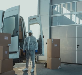 a man in a white coat is walking out of a van