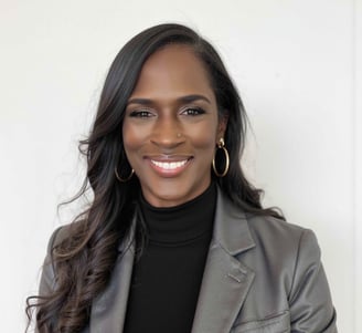 a woman in a gray suit and black top
