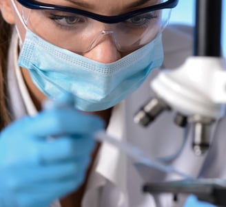 a woman in a lab coat and a mask on