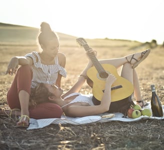 two women playing guitar