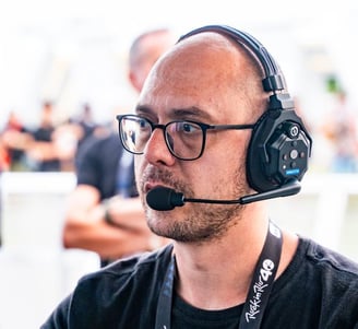 a man with a headset and a microphone in front of a microphone