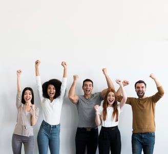 a group of people standing in front of a white wall