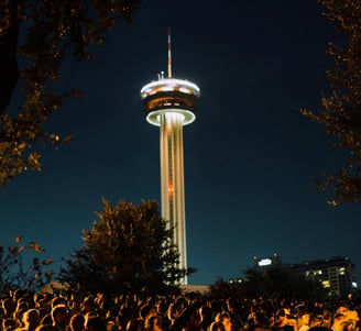 A crowd of san antonio texas people in front of the Tower of Americas